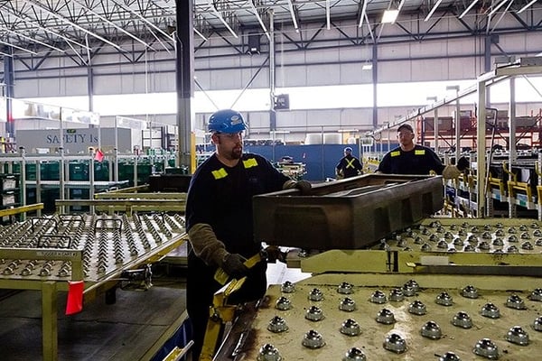 Workers in an automotive facility