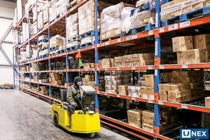 UNEX Span-Track Wheel Bed in large freezer cooler area for grocer distribution.